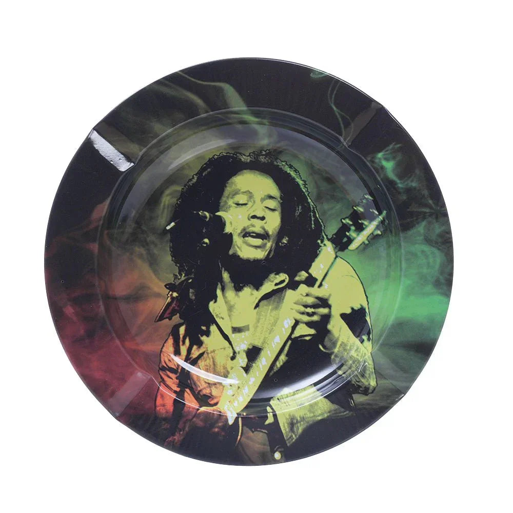 Round black ashtray featuring a colorful image of Bob Marley playing guitar with red and green smoke background