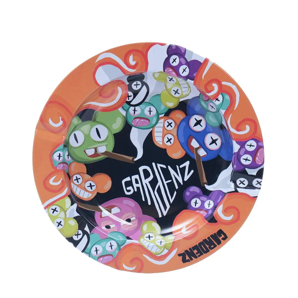 Colorful round ashtray with cartoon skull faces smoking cigars and Gardenz logo on orange border