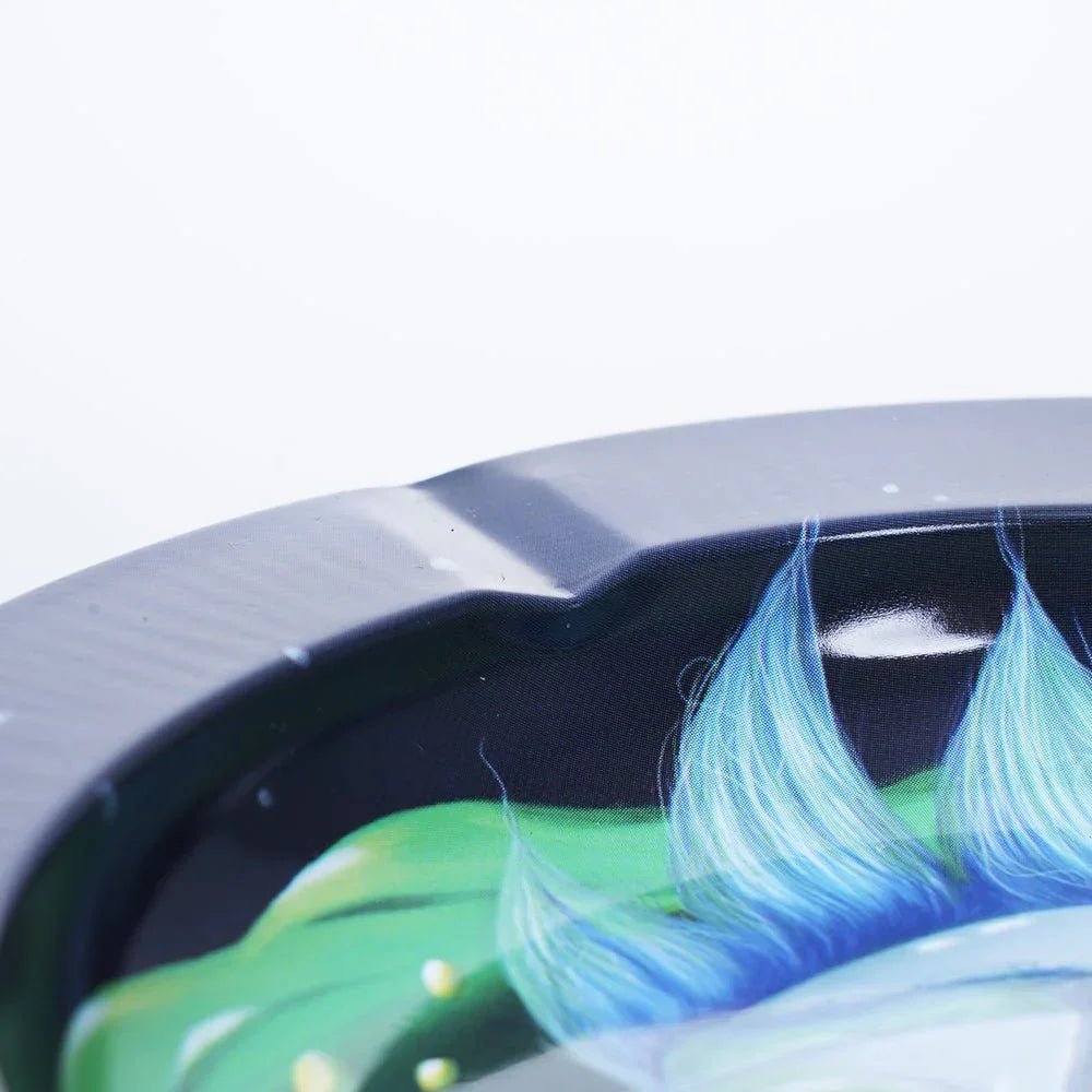 Close-up of black ashtray with colorful blue and green feather design detail