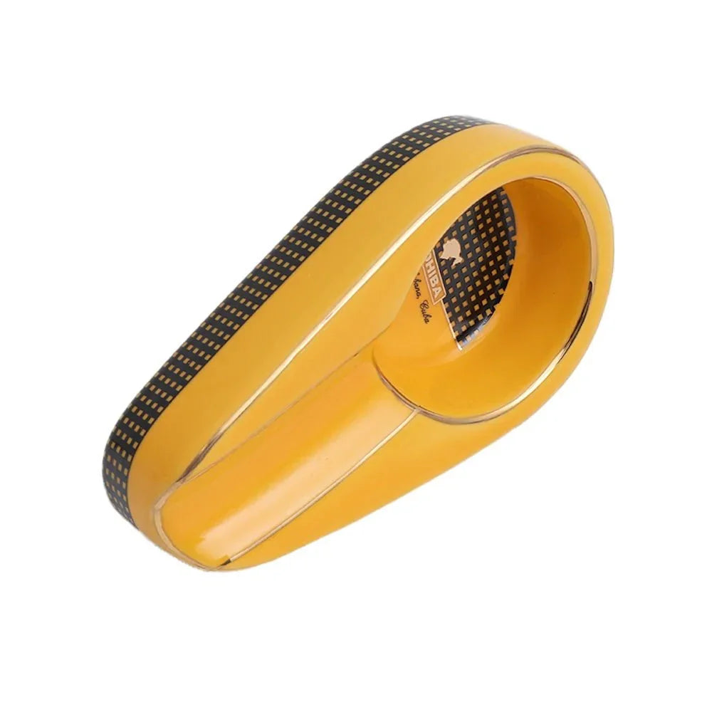 Yellow and black ceramic cigar ashtray with patterned details and Cuban branding