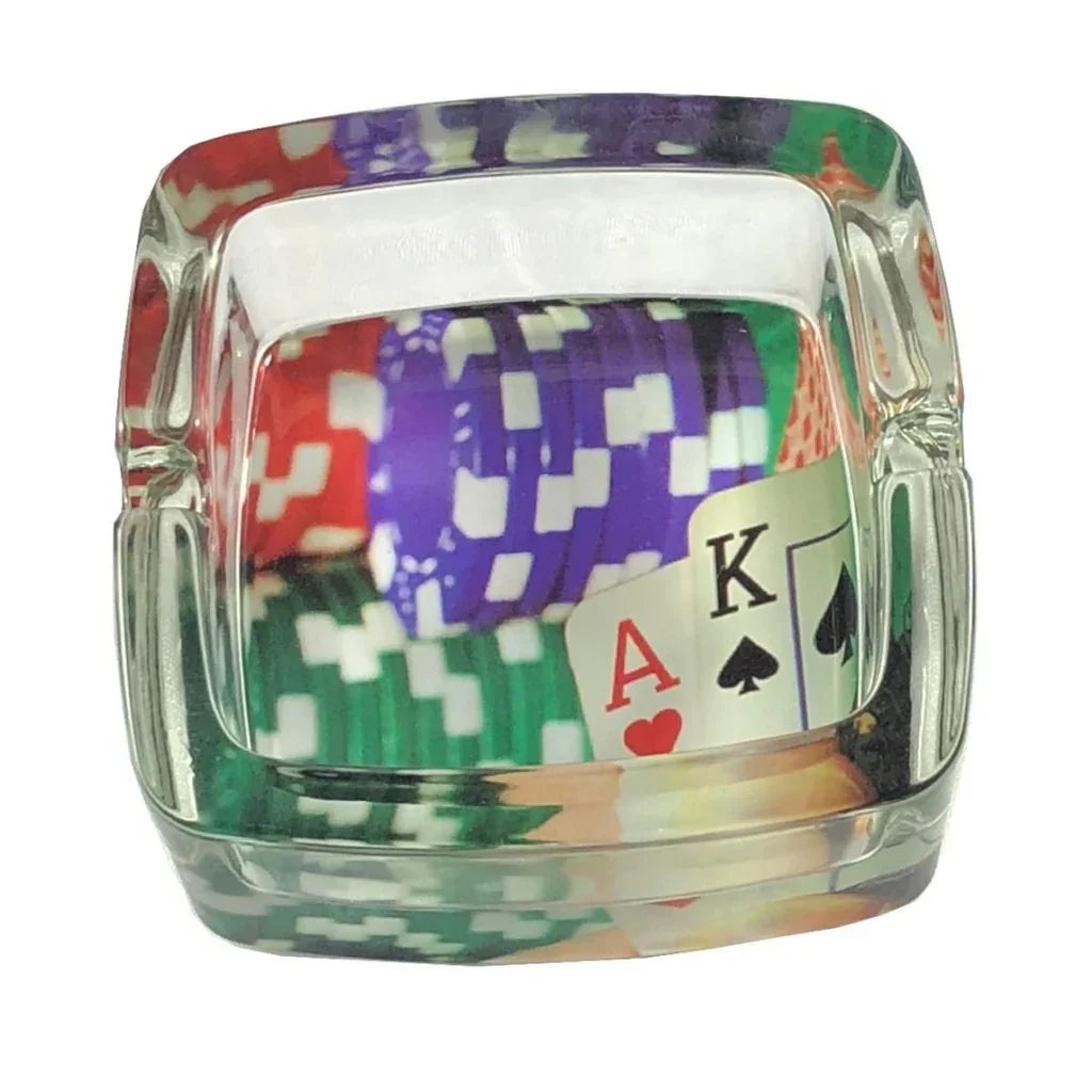 Glass ashtray with poker chips and playing cards ace and king of spades and hearts