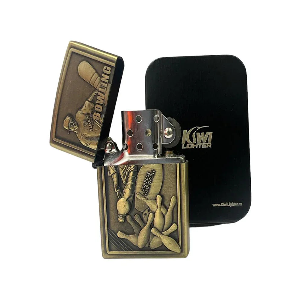 Antique brass bowling-themed metal lighter with embossed bowler and pins, open lid, black Kiwi Lighter case