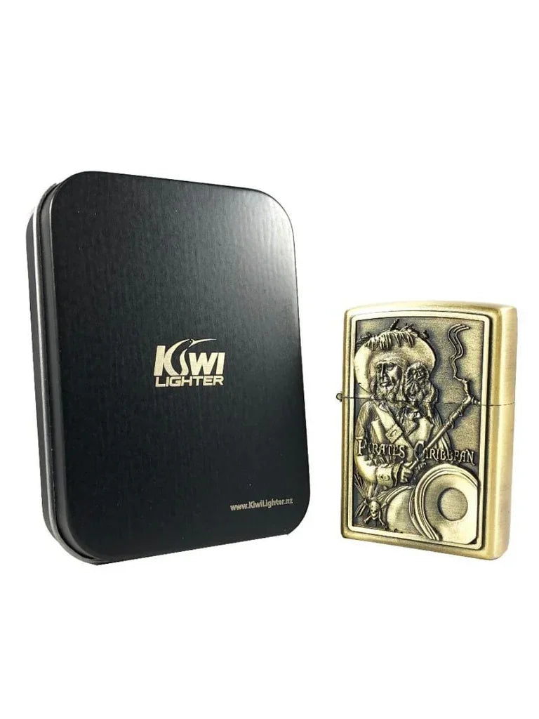 Gold metal lighter with Pirates of the Caribbean engraving next to black Kiwi Lighter case