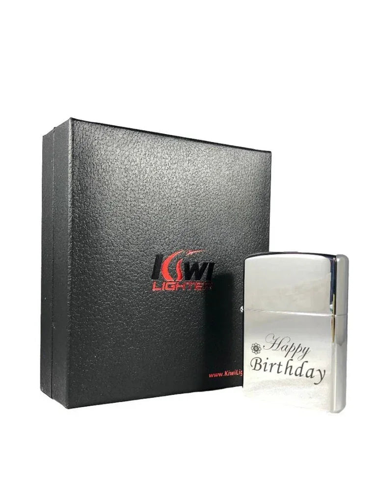 Silver metal lighter engraved with Happy Birthday text beside black textured Kiwi Lighters box