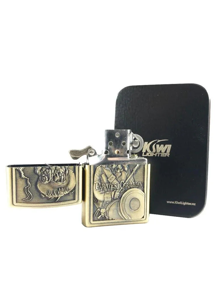 Brass Pirates of the Caribbean themed flint lighter with embossed pirate design and Kiwi Lighter black tin box