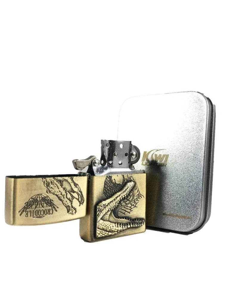 Antique brass lighter with engraved crocodile design and matching metal storage tin