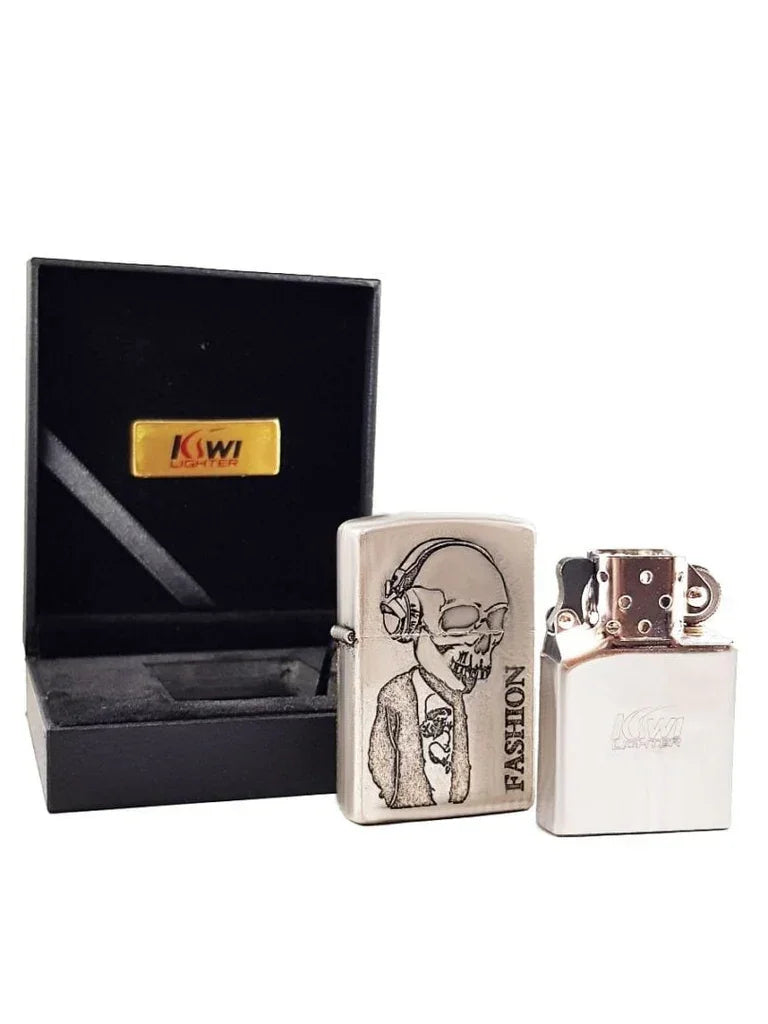 Silver metal lighter with engraved skull wearing headphones and tie, labeled FASHION, next to opened black gift box