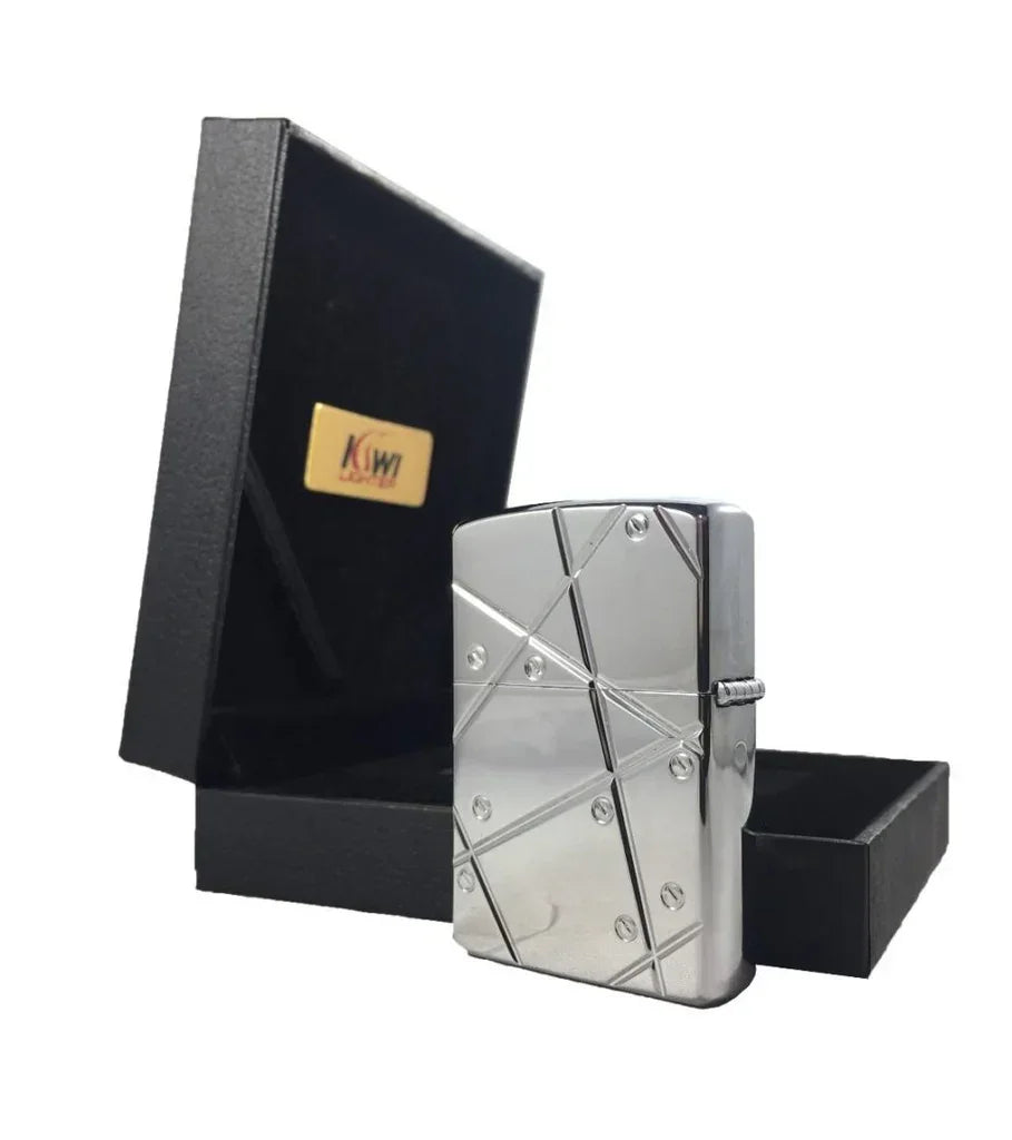 Polished silver metal lighter with geometric engravings next to black gift box with gold logo