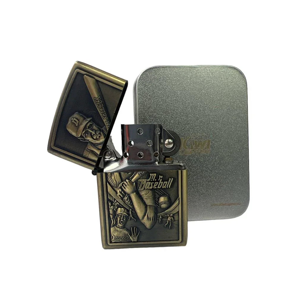 Antique brass baseball-themed flint lighter with detailed engraving and grey tin case