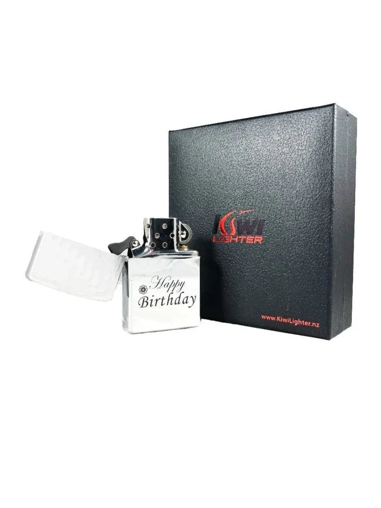 Silver metal lighter with Happy Birthday engraving, open lid, beside black Kiwi Lighter gift box