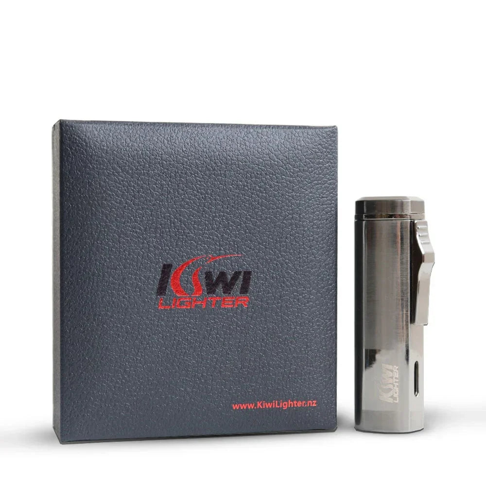 Kiwi Lighter metal torch lighter with clip beside textured black box packaging