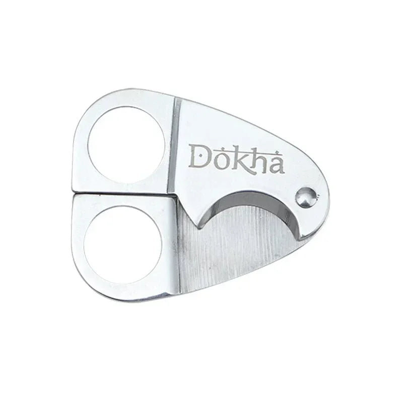 Silver Dokha tobacco cutter with dual finger holes and sharp curved blade on white background